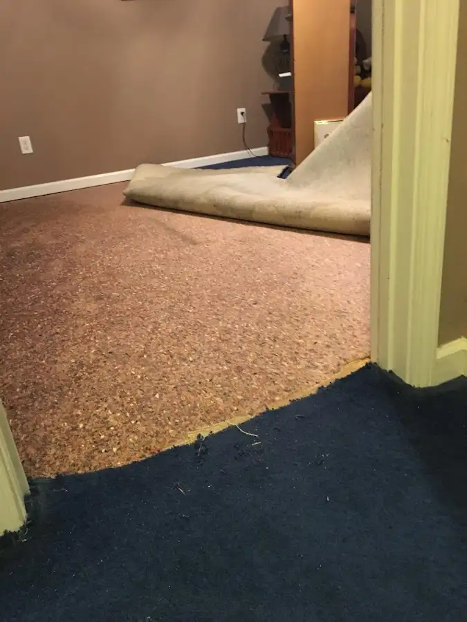 Carpet pad removal revealing water damage during Water Mitigation Services in Luling